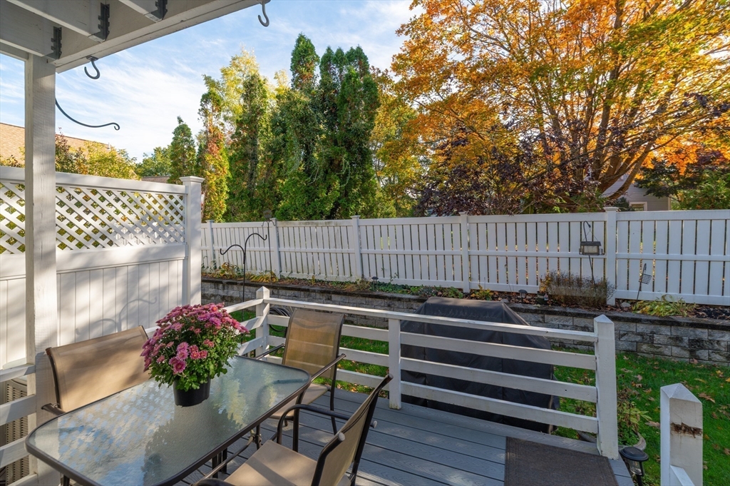 38 Kimball Avenue, Unit 5 Ipswich, MA 01938 - Photo 11 of 22 a view of a chairs and tables in the back yard of the house