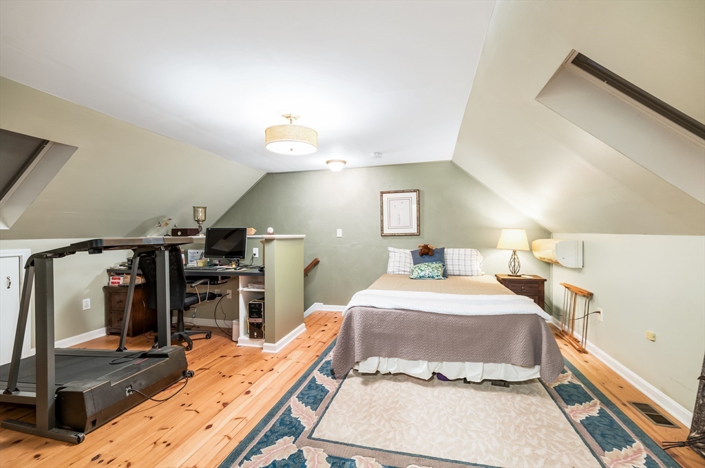 38 Kimball Avenue, Unit 5 Ipswich, MA 01938 - Photo 16 of 22 a bedroom with a bed and flat screen tv