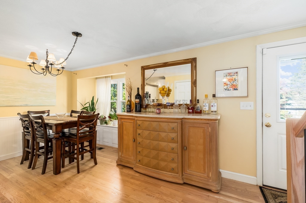 38 Kimball Avenue, Unit 5 Ipswich, MA 01938 - Photo 4 of 22 a dining hall with stainless steel appliances granite countertop a dining table and chairs with wooden floor