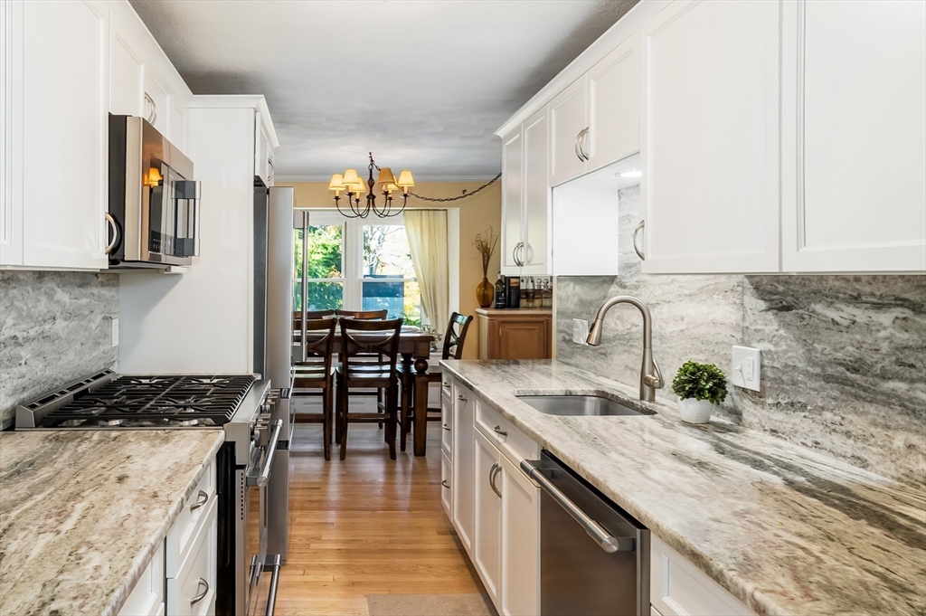 38 Kimball Avenue, Unit 5 Ipswich, MA 01938 - Photo 6 of 22 a kitchen with granite countertop a sink stove and cabinets