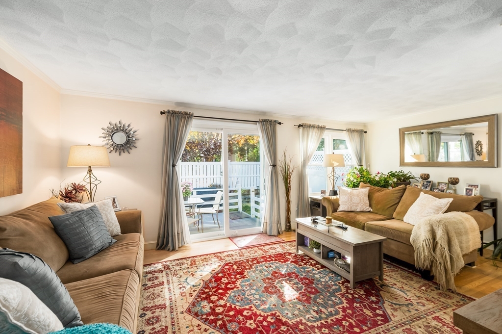 38 Kimball Avenue, Unit 5 Ipswich, MA 01938 - Photo 7 of 22 a living room with furniture and a large window