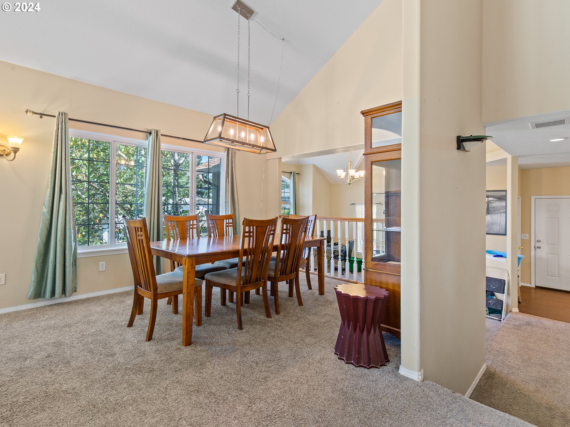 3940 Northeast Franklin Street Camas, WA 98607 - Photo 2 of 21 a dining room with furniture floor to ceiling windows and a rug