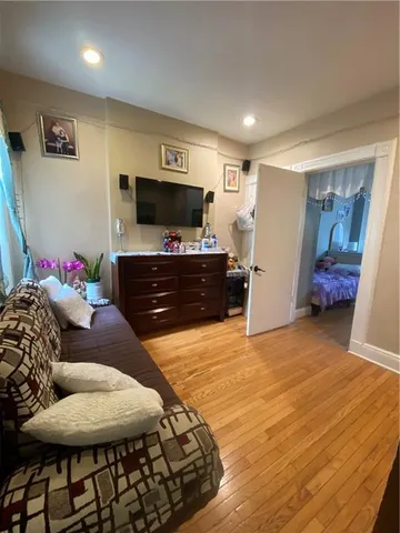a bedroom with furniture and a flat screen tv