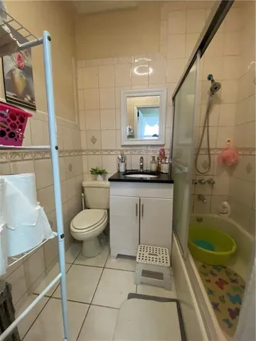 a bed room with a bed a couch and a chandelier