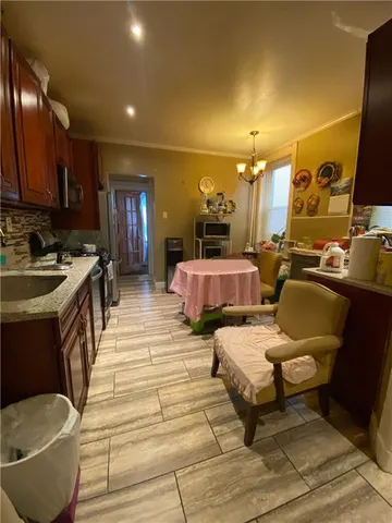 a bedroom with a bed dresser and a kitchen island