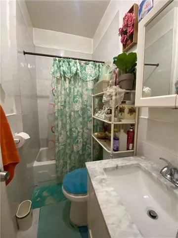 a bedroom with a bed and teddy bear on bed