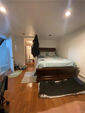 a bedroom with a large bed and a chandelier