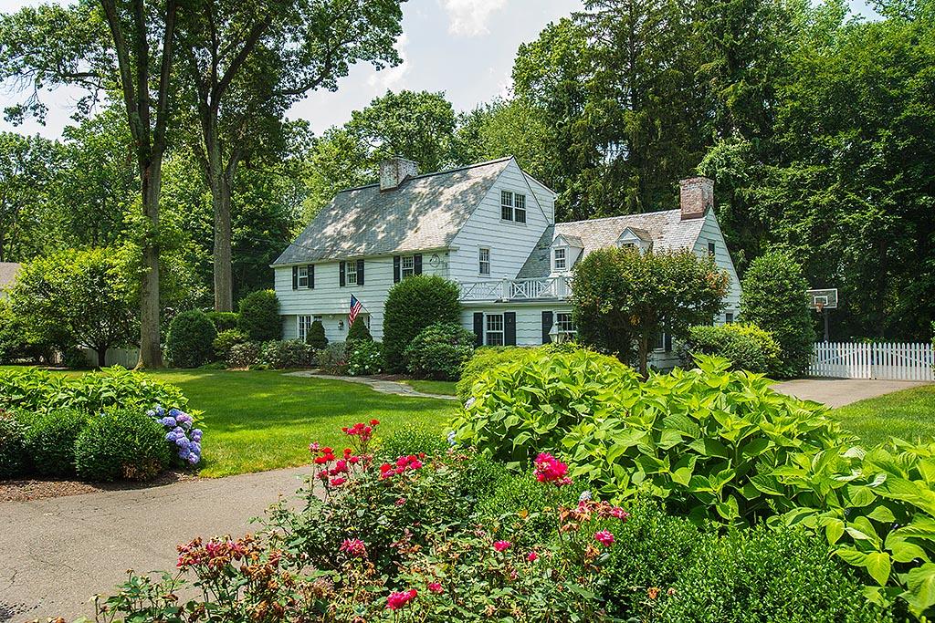 33 Birch Road Darien, CT 06820 - Photo 2 of 33 a front view of a house with a big yard and potted plants