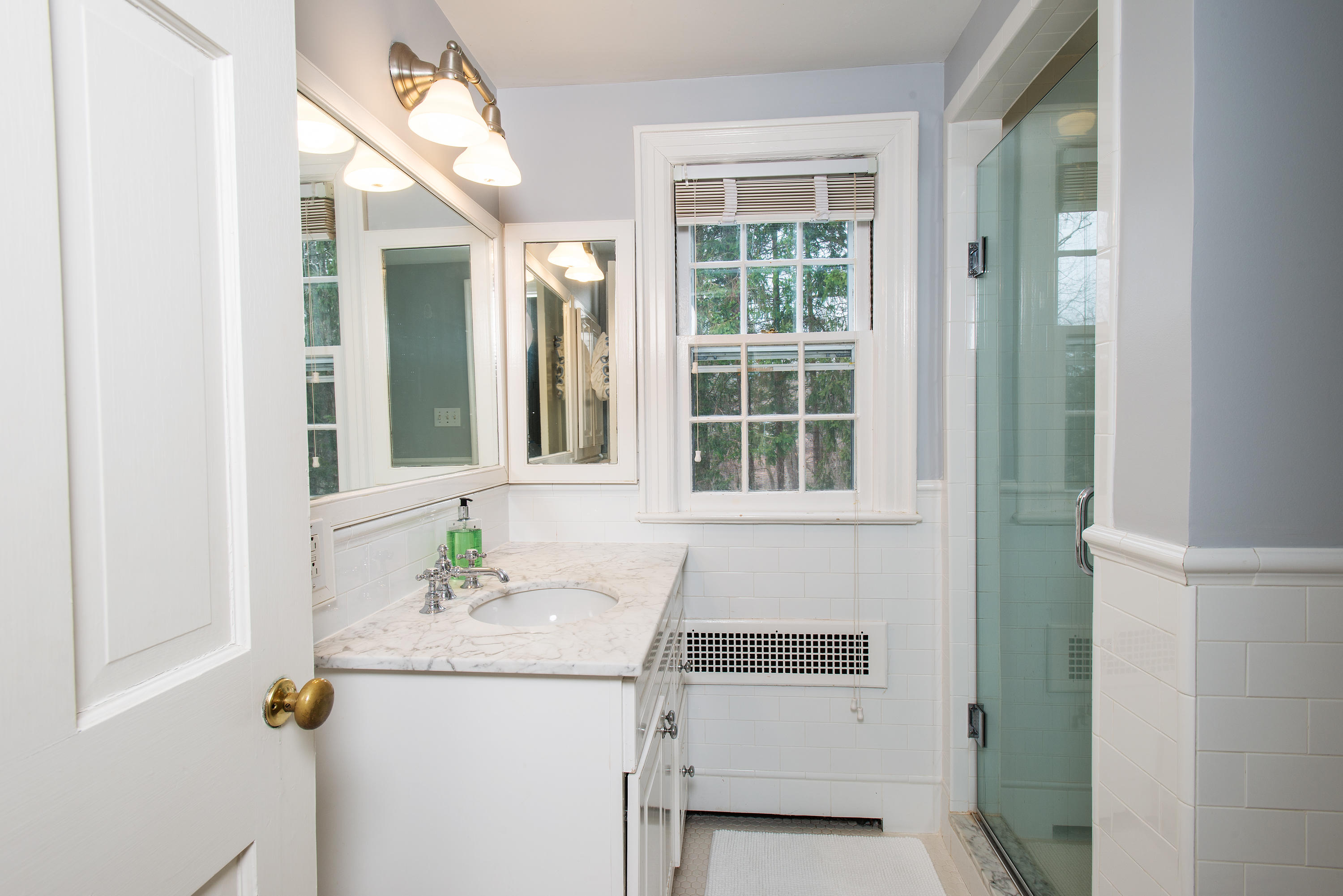 33 Birch Road Darien, CT 06820 - Photo 13 of 33 a bathroom with a sink and a mirror