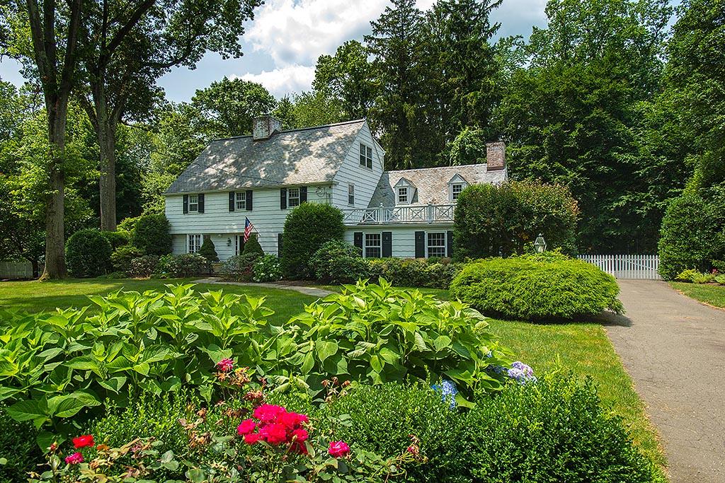 33 Birch Road Darien, CT 06820 - Photo 22 of 33 a front view of a house with a yard and fountain in middle
