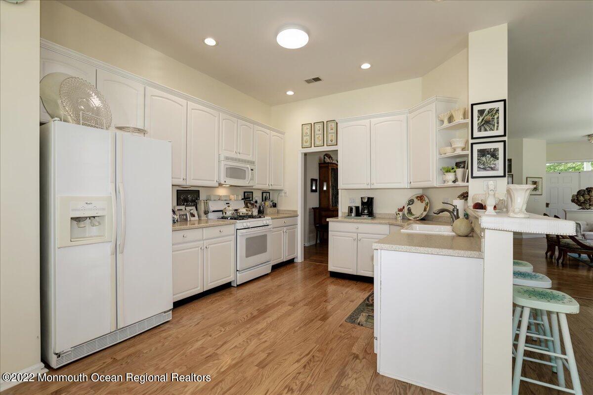 2513 Morningstar Road Manasquan, NJ 08736 - Photo 30 of 69 a kitchen with white cabinets and white appliances