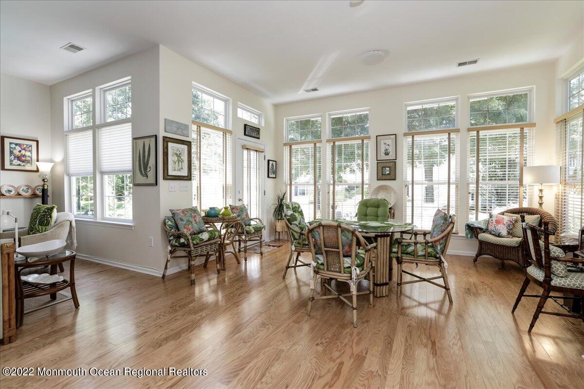 2513 Morningstar Road Manasquan, NJ 08736 - Photo 34 of 69 a dining room with wooden floor a glass table and a large window