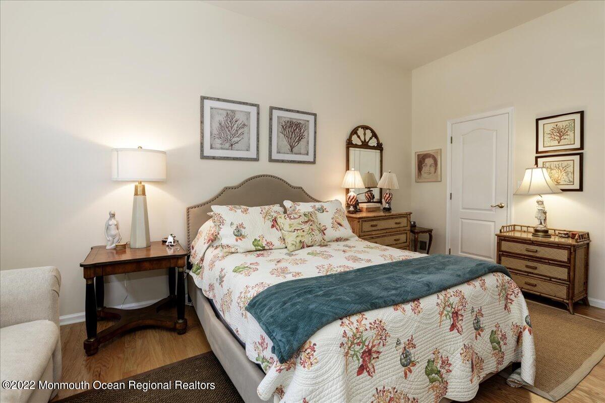 2513 Morningstar Road Manasquan, NJ 08736 - Photo 45 of 69 a bedroom with a bed a table and chair