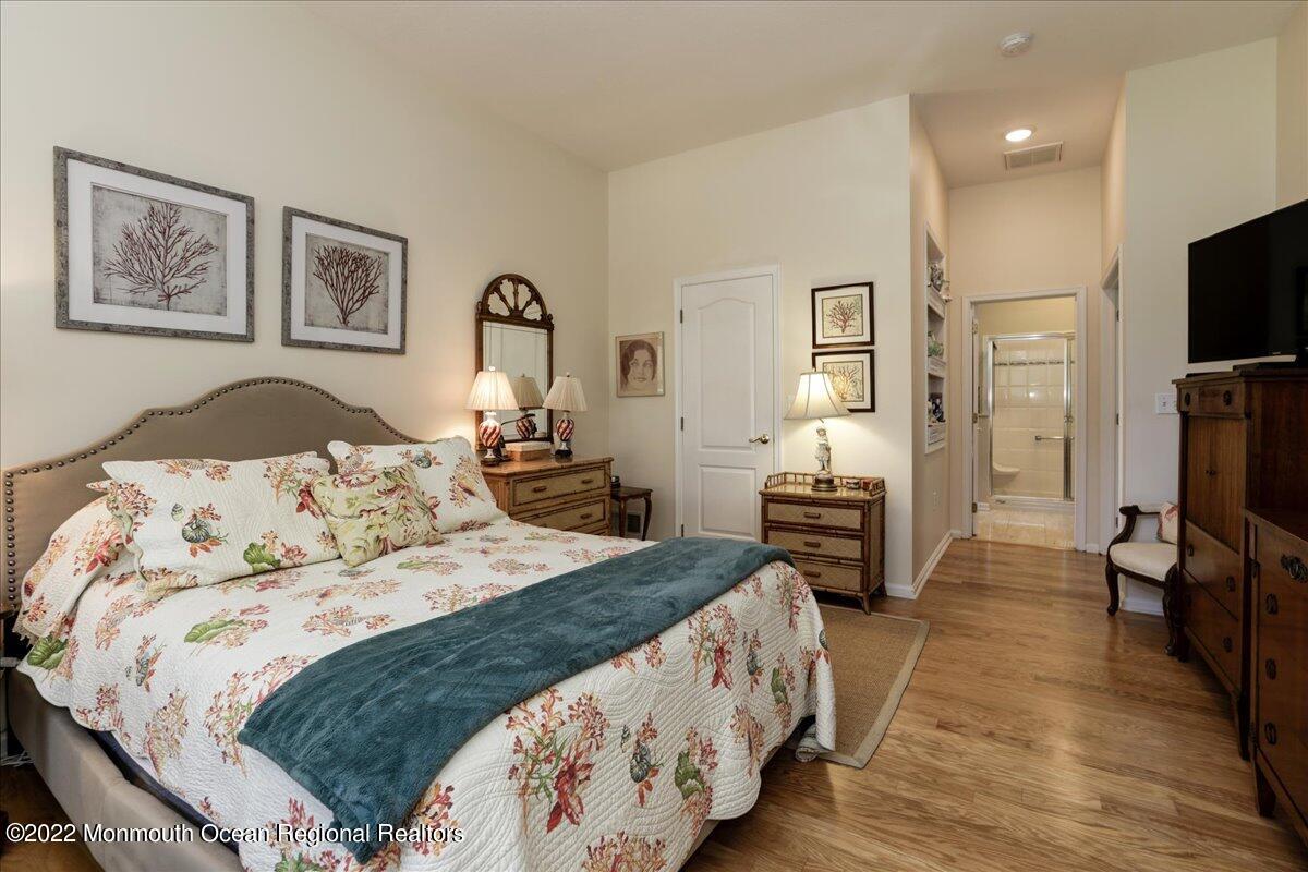 2513 Morningstar Road Manasquan, NJ 08736 - Photo 46 of 69 a bedroom with a bed a mirror and desk