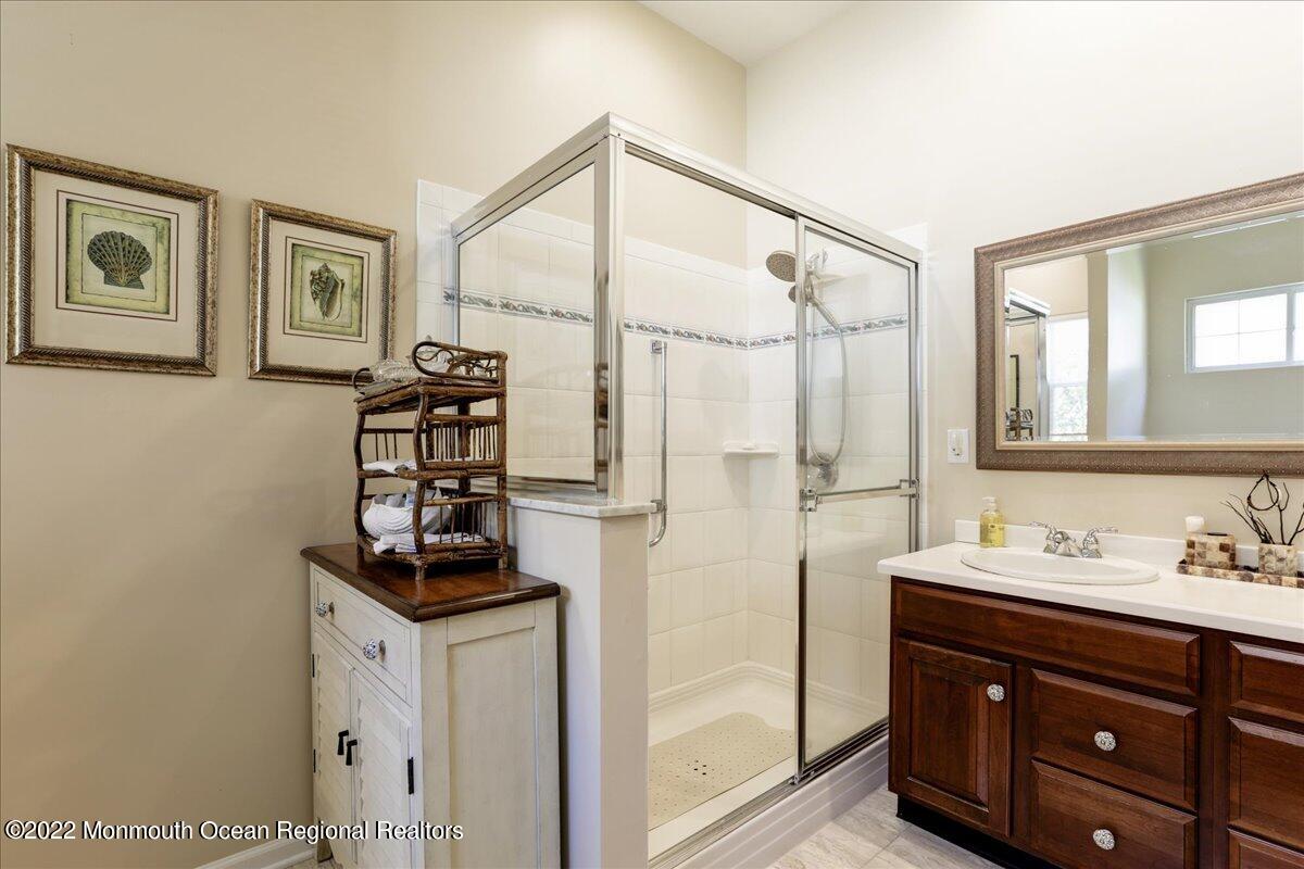 2513 Morningstar Road Manasquan, NJ 08736 - Photo 48 of 69 a bathroom with a sink a mirror and a shower