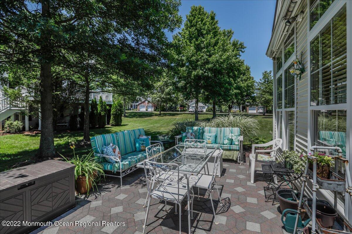 2513 Morningstar Road Manasquan, NJ 08736 - Photo 58 of 69 a view of a chairs and table in patio with a yard
