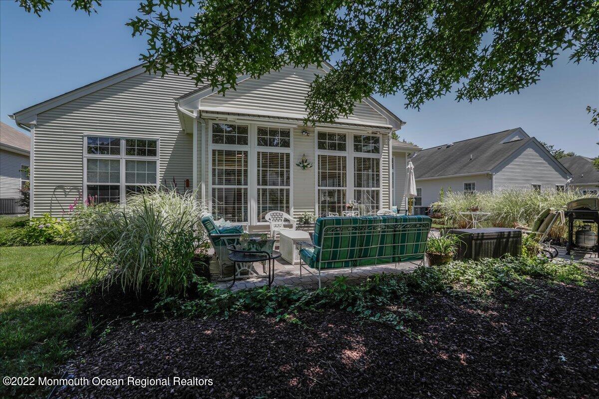 2513 Morningstar Road Manasquan, NJ 08736 - Photo 64 of 69 a front view of a house with a garden and sitting area