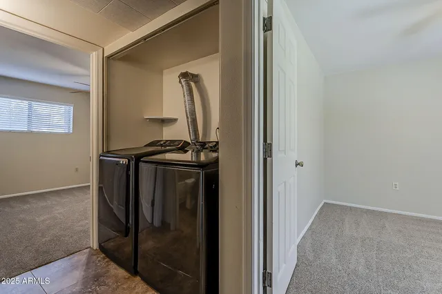 a view of walk in closet with clothes