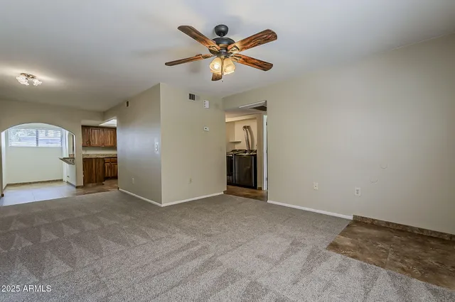 an empty room with closet and windows
