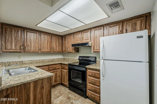 a kitchen with a sink a stove and refrigerator