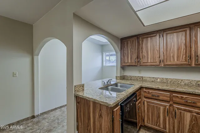 a kitchen with a sink a cabinets and window