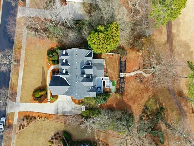 an aerial view of a house with swimming pool and patio