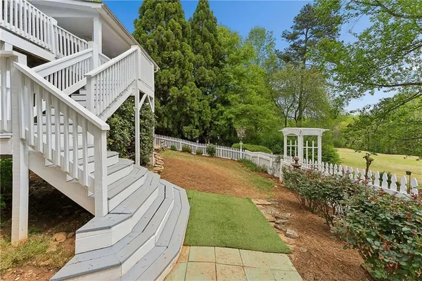 a spacious bedroom with a bed and a flat screen tv
