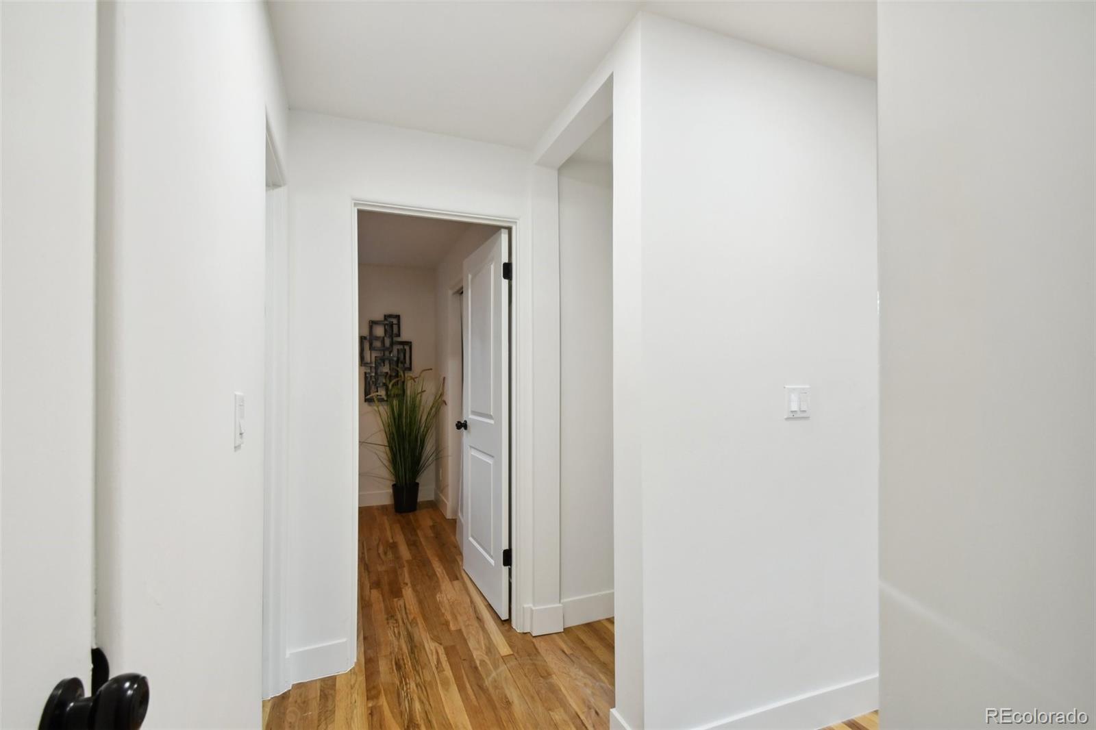 6650 West 46th Place Wheat Ridge, CO 80033 - Photo 14 of 23 a view of a hallway with wooden floor