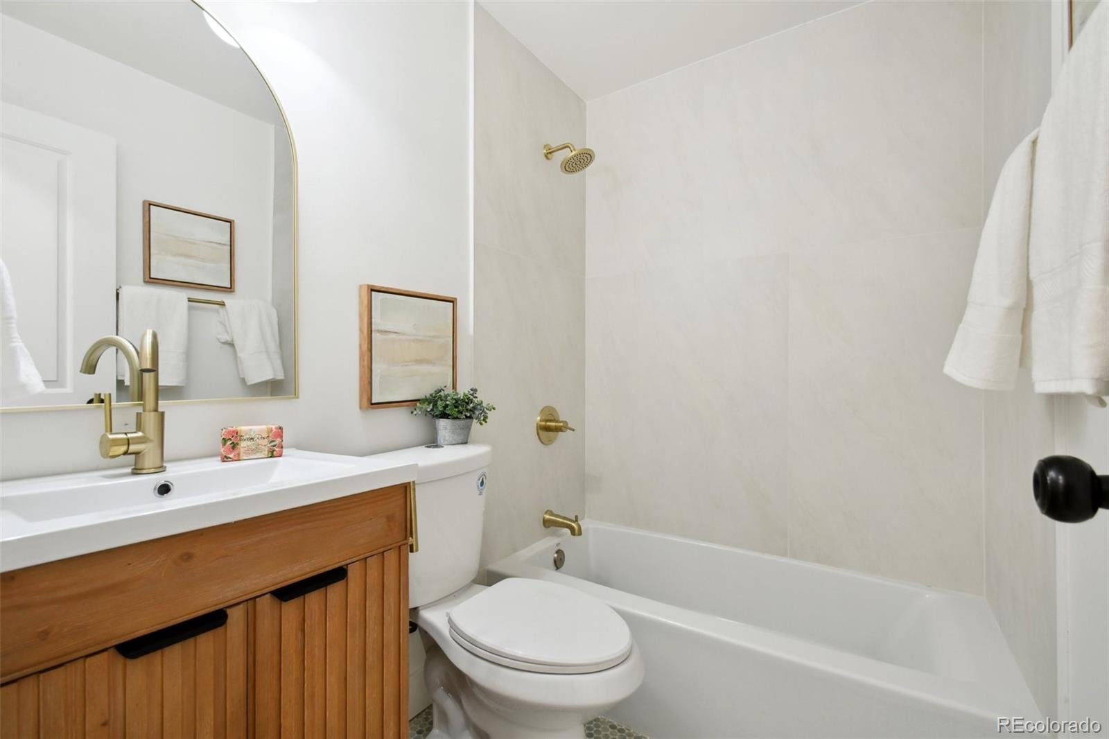 6650 West 46th Place Wheat Ridge, CO 80033 - Photo 18 of 23 a bathroom with a sink a toilet and shower