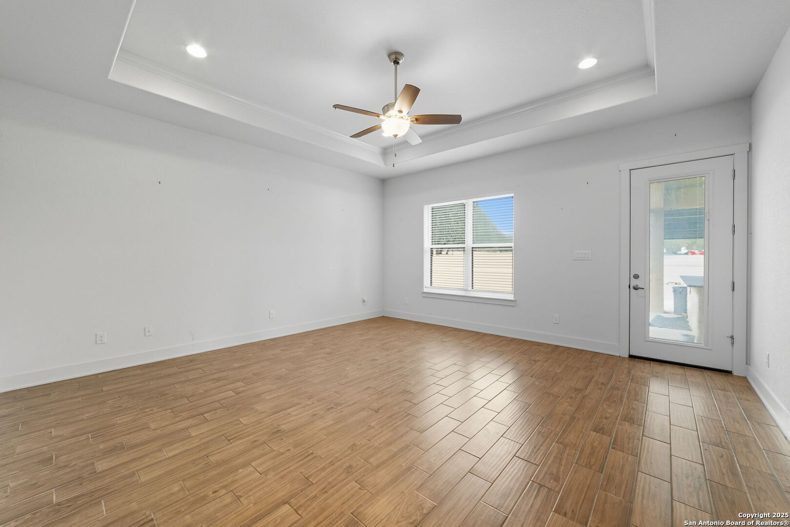 3172 Interstate 35 Natalia, TX 78059 - Photo 13 of 26 wooden floor in an empty room with a window