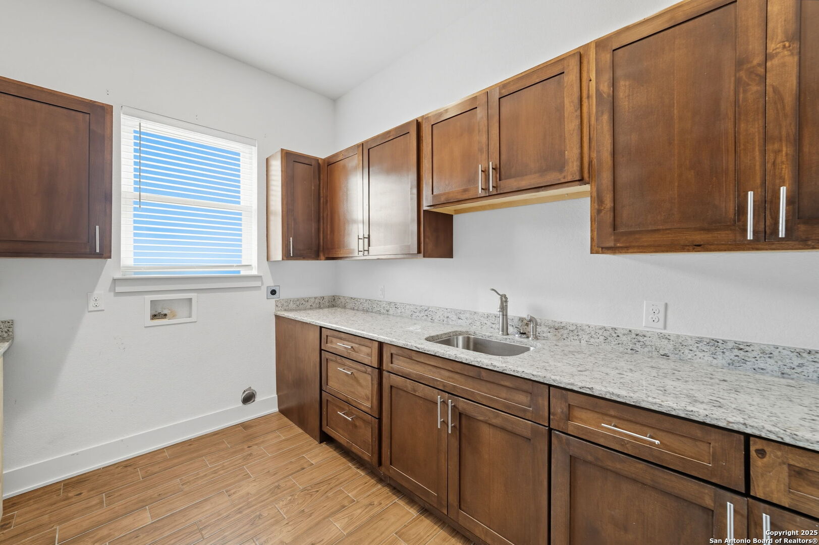 3172 Interstate 35 Natalia, TX 78059 - Photo 20 of 26 a kitchen with a sink cabinets and wooden floor