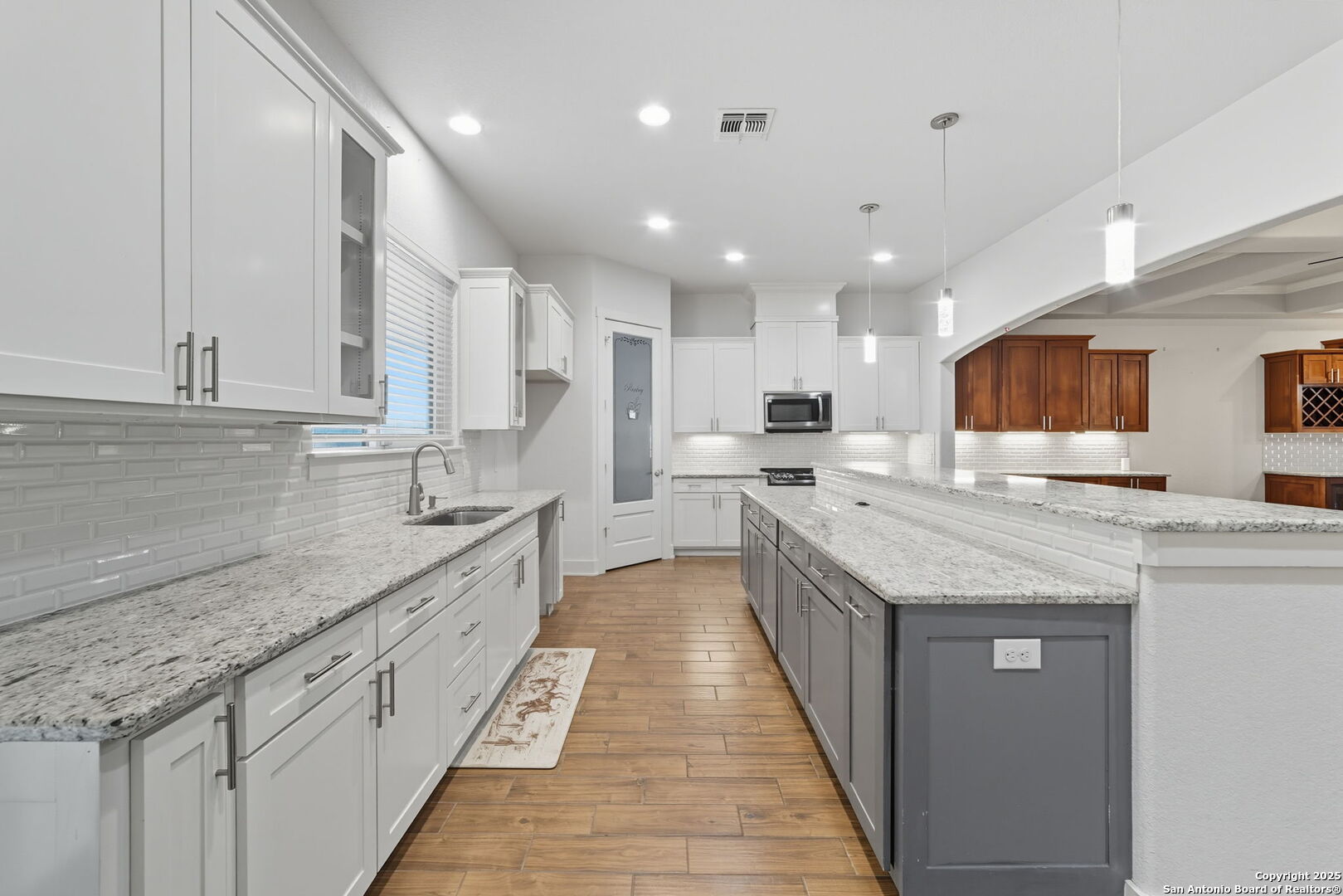3172 Interstate 35 Natalia, TX 78059 - Photo 9 of 26 a large kitchen with stainless steel appliances kitchen island granite countertop a sink and cabinets