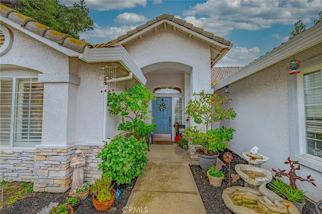 a living room with couches and kitchen view with wooden floor