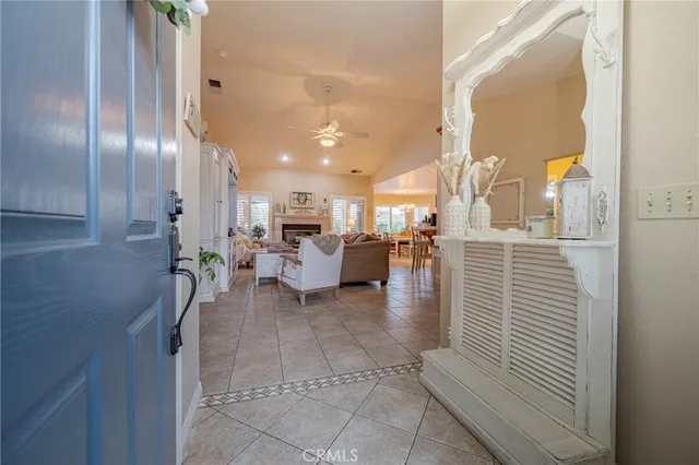 a living room with furniture a large window and a fireplace