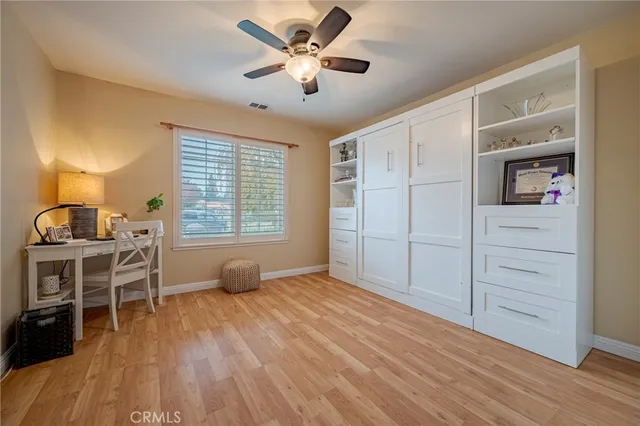 a living room with furniture and a bookshelf