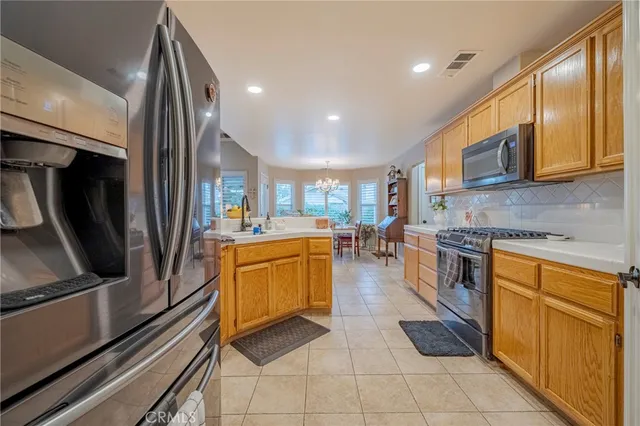 a kitchen with stainless steel appliances granite countertop a stove and a microwave