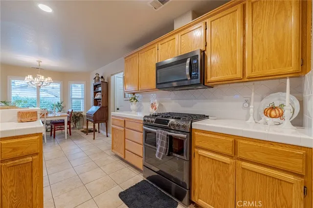 a kitchen with a stove a sink and a microwave