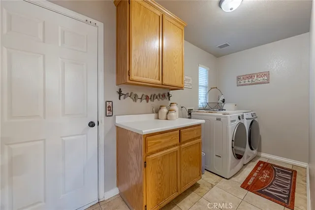 a front view of a house with a big yard and potted plants