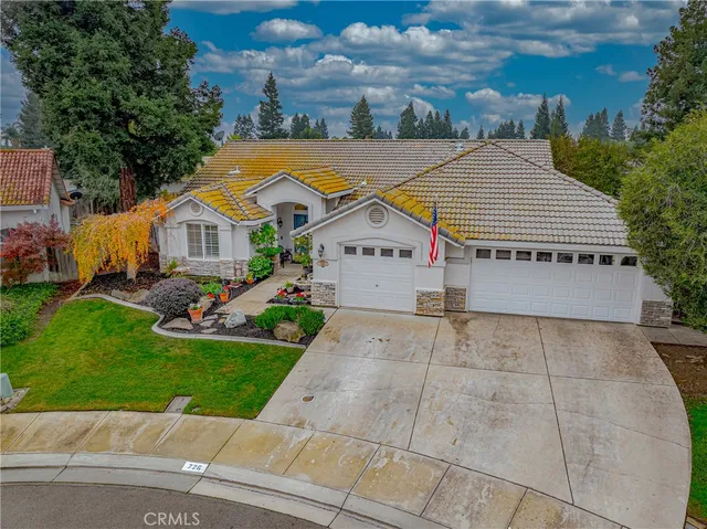 an aerial view of a house with a yard and potted plants
