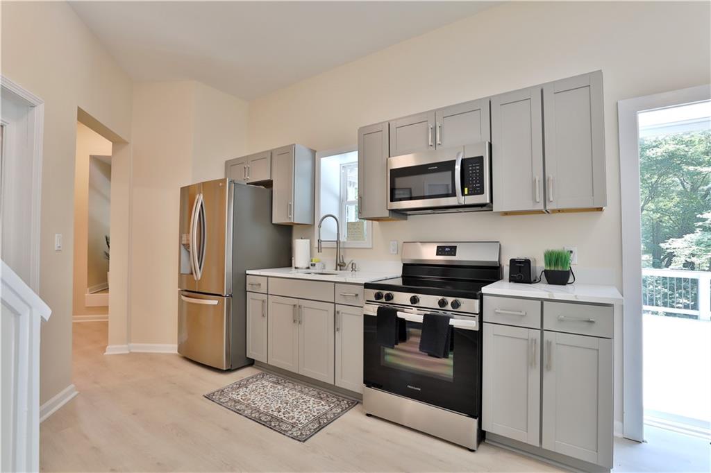2125 Clay Road Southwest Austell, GA 30106 - Photo 19 of 25 a kitchen with stainless steel appliances granite countertop a stove a refrigerator and a microwave