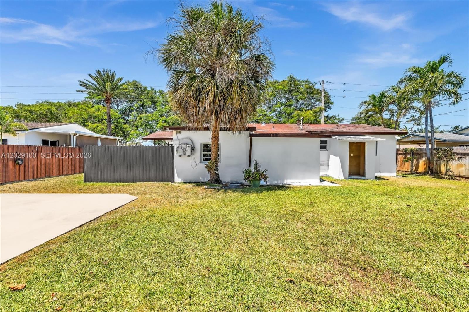 11790 Southwest 34th Street Miami, FL 33175 - Photo 51 of 56 front view of a house with a yard and a garage