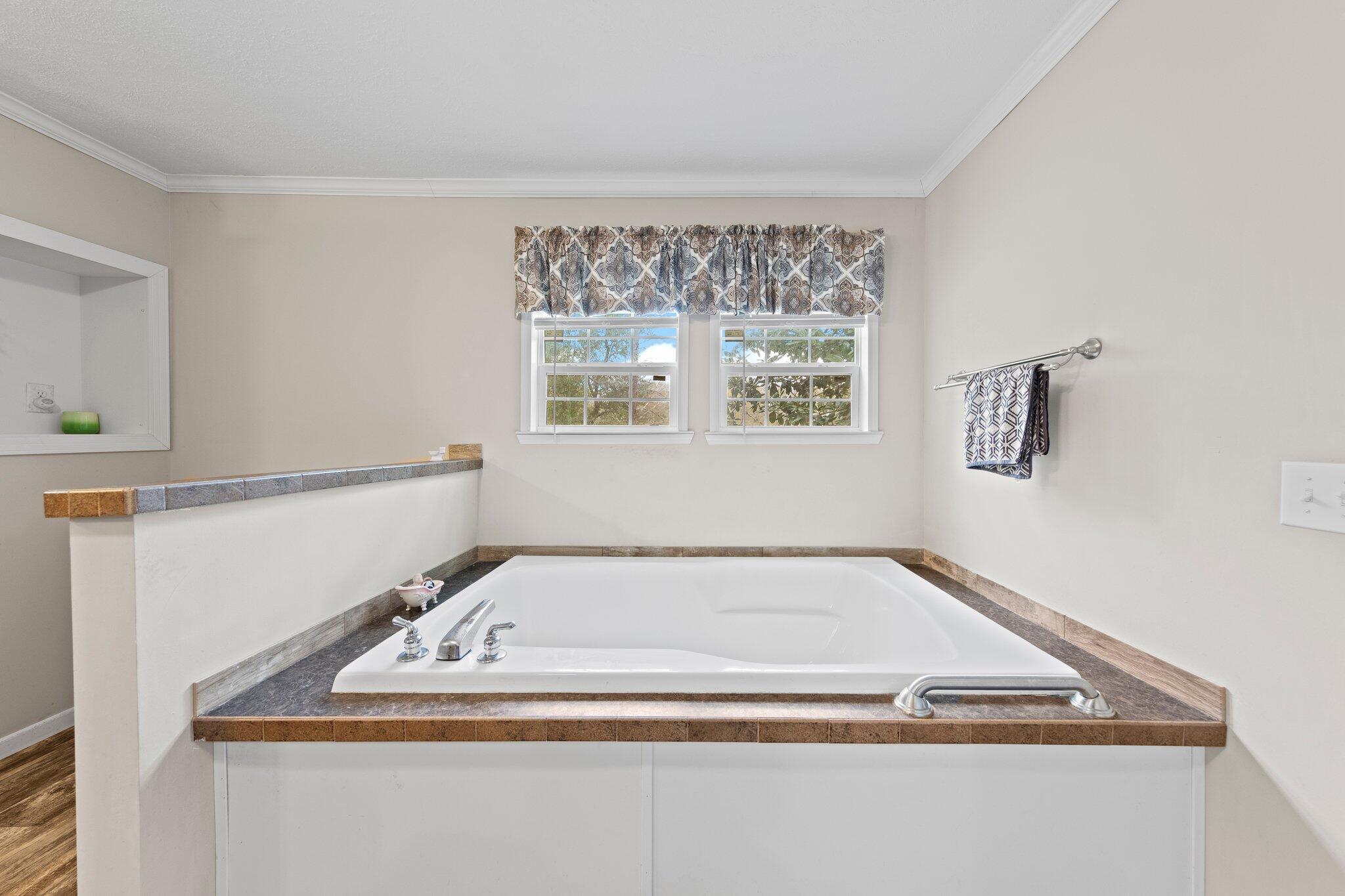 830 Squirrel Road DeFuniak Springs, FL 32433 - Photo 13 of 30 a bathroom with a bath tub