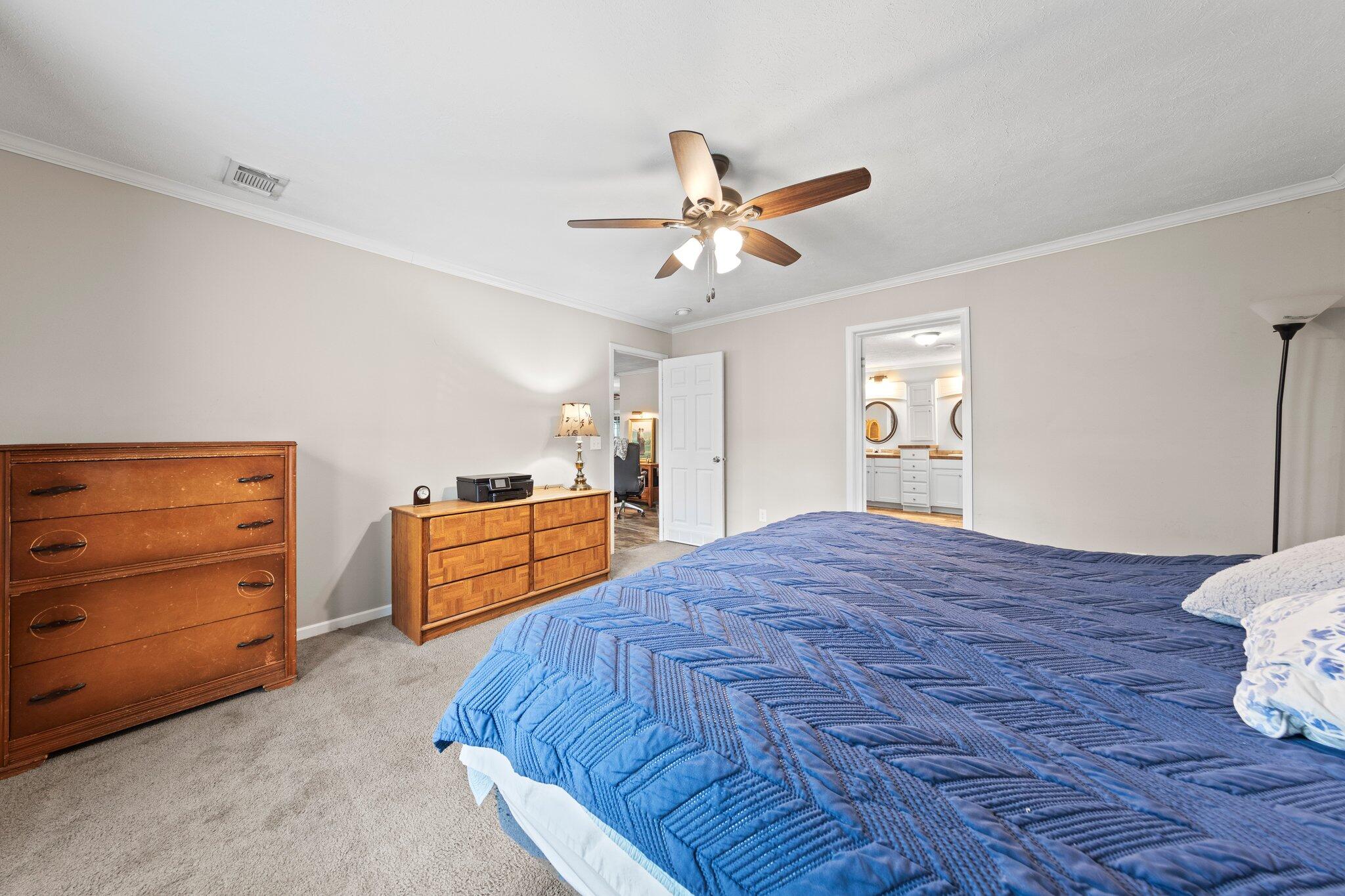 830 Squirrel Road DeFuniak Springs, FL 32433 - Photo 18 of 30 a bedroom with a bed and a dresser