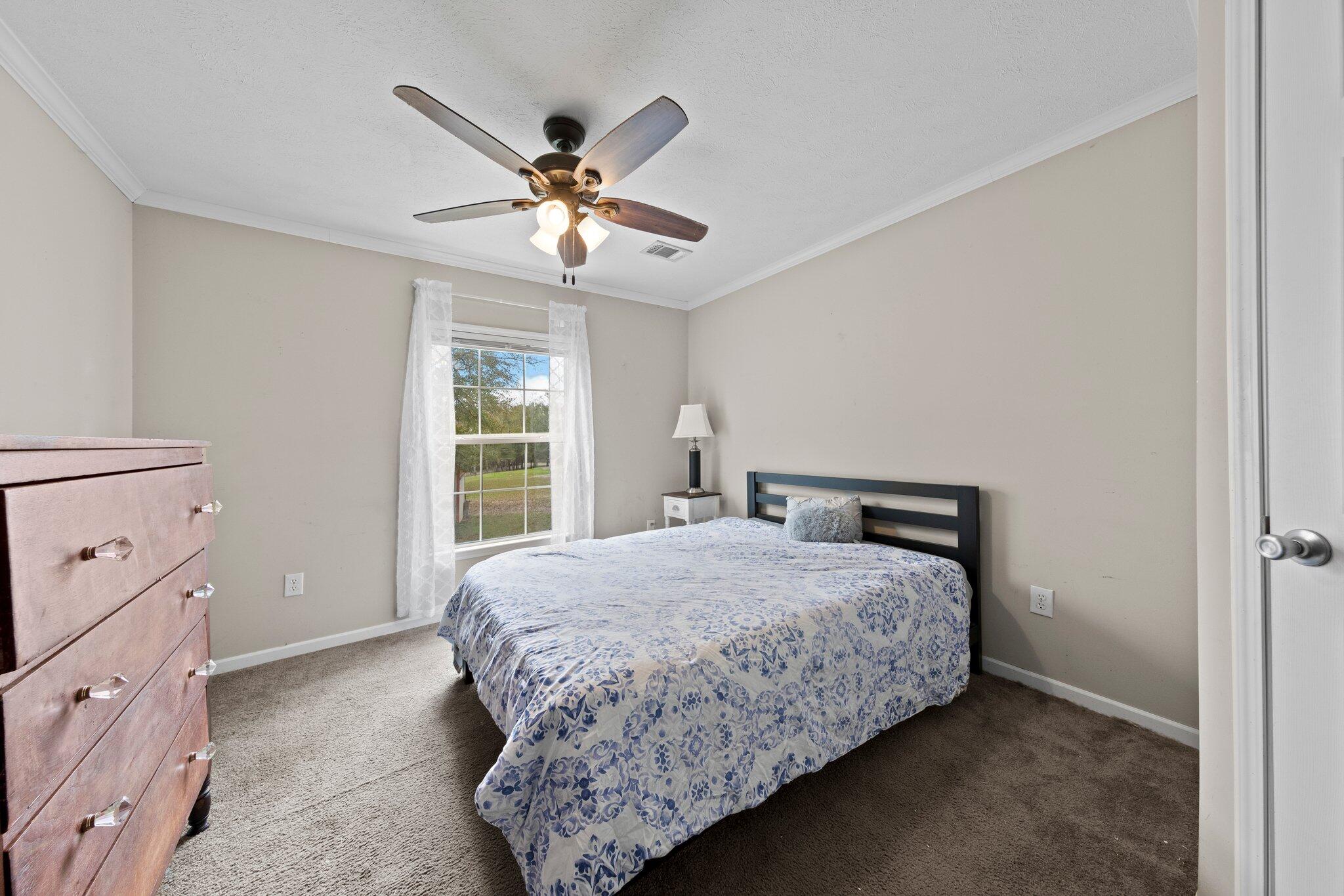 830 Squirrel Road DeFuniak Springs, FL 32433 - Photo 19 of 30 a bedroom with a bed and a window