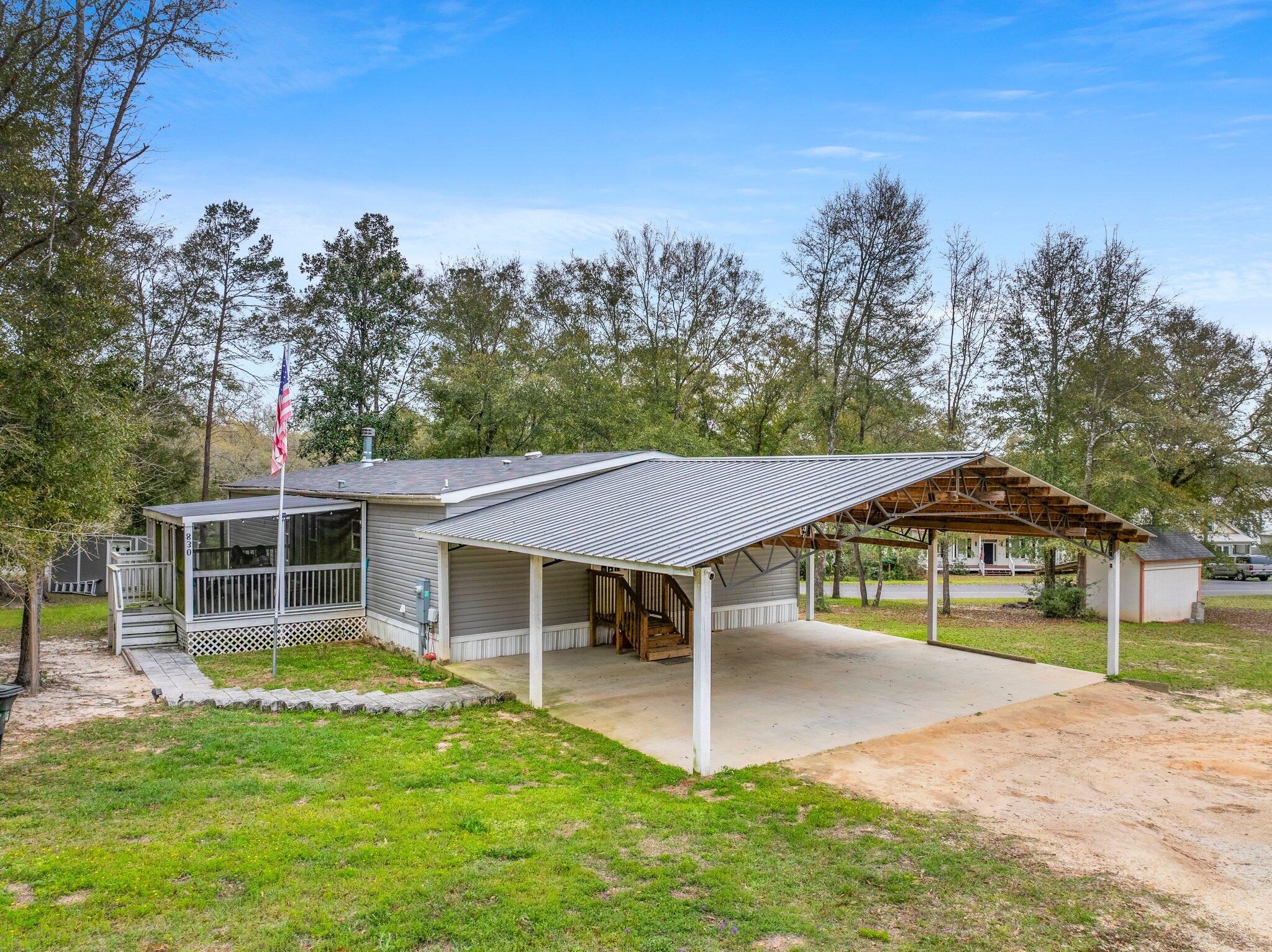 830 Squirrel Road DeFuniak Springs, FL 32433 - Photo 25 of 30 aerial view of a house with a yard table and chairs