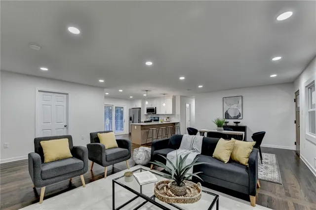 a living room with furniture and a wooden floor