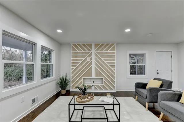 a living room with furniture and a large window