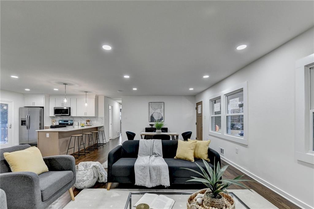 2137 Plantation Lane Chamblee, GA 30341 - Photo 15 of 54 a living room with furniture kitchen view and a wooden floor