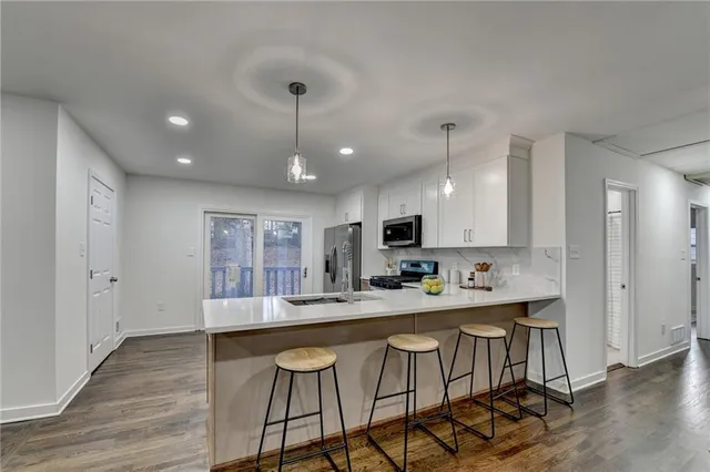 a kitchen with stainless steel appliances kitchen island a chandelier