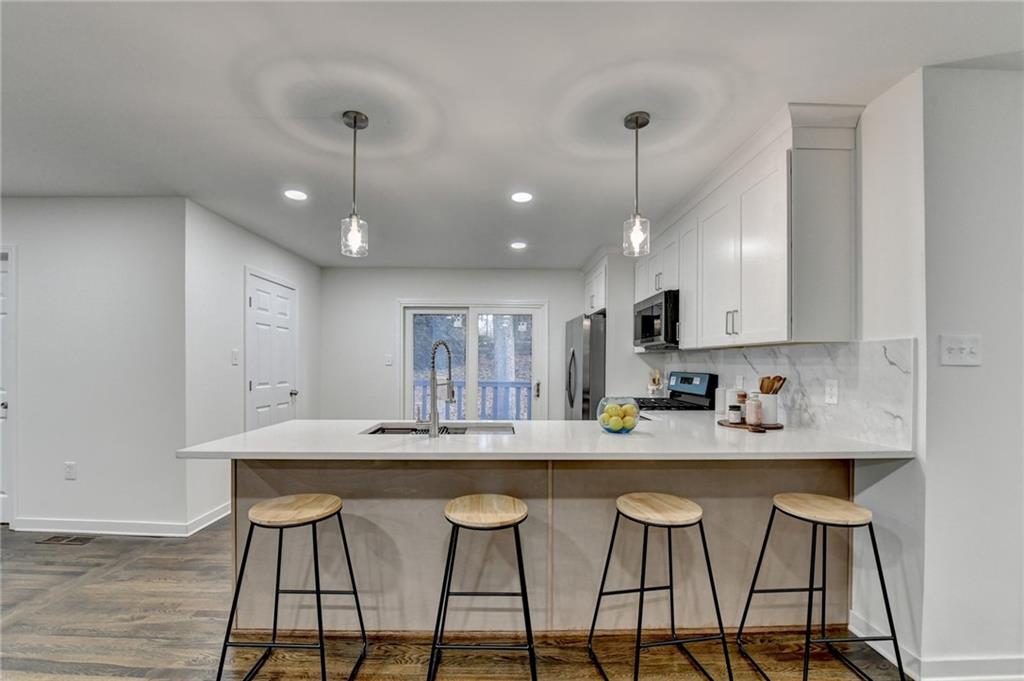 2137 Plantation Lane Chamblee, GA 30341 - Photo 21 of 54 a kitchen with stainless steel appliances kitchen island a chandelier